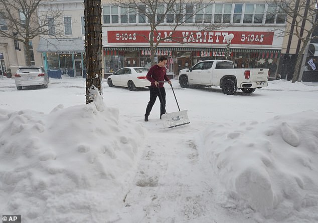 A resident clears a Michigan sidewalk on Thursday