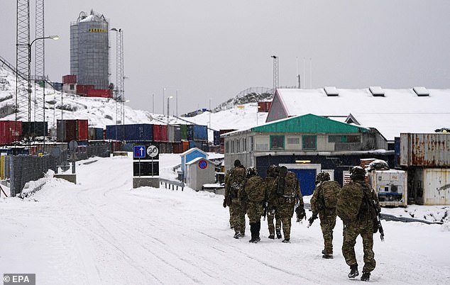 Danish soldiers walk on a street after disembarking at the port in Nuuk, Greenland on Sunday