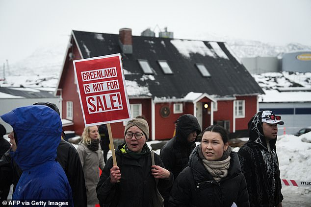 Young people with placards reading 'Greenland is not for sale!' take part in a demonstration that gathered almost a third of the city population to protest against the Trump's plans to take Greenland