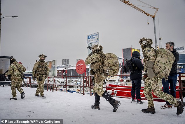 Danish soldiers are seen disembarking at the port in Nuuk, Greenland