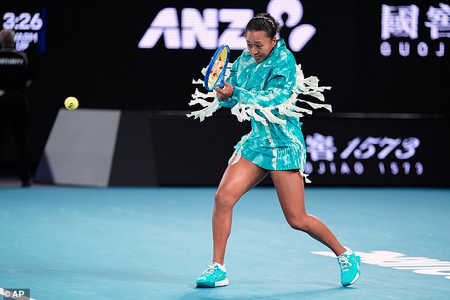 The Japanese tennis star turned heads as she entered Rod Laver Arena wearing a long turquoise 'jellyfish'-inspired tunic