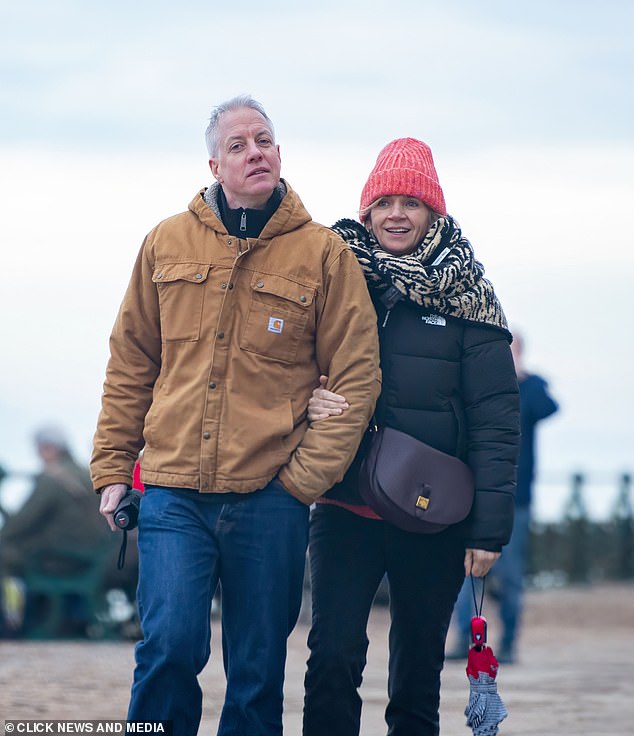Bundled up in a beanie hat and animal-print scarf, Zoe beamed as she walked arm in arm with Mathieu in her home town