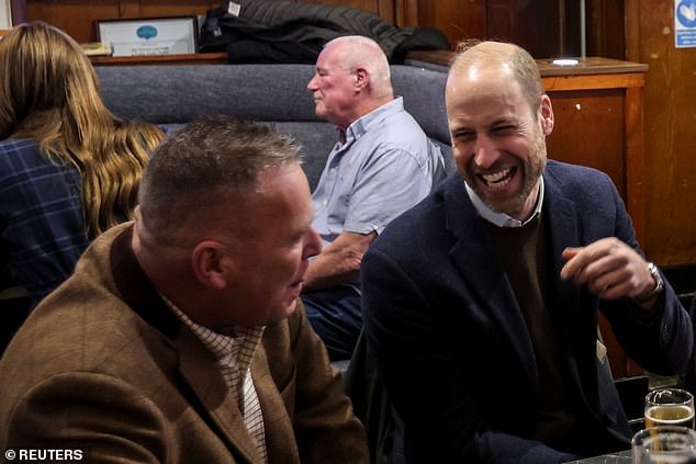 William, Prince of Wales, talks to people at 'The Gothenburg', known locally as 'The Goth'