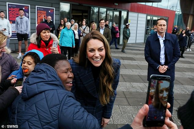 A royal fan poses for a photo with Catherine outside the National Curling Academy in Stirling