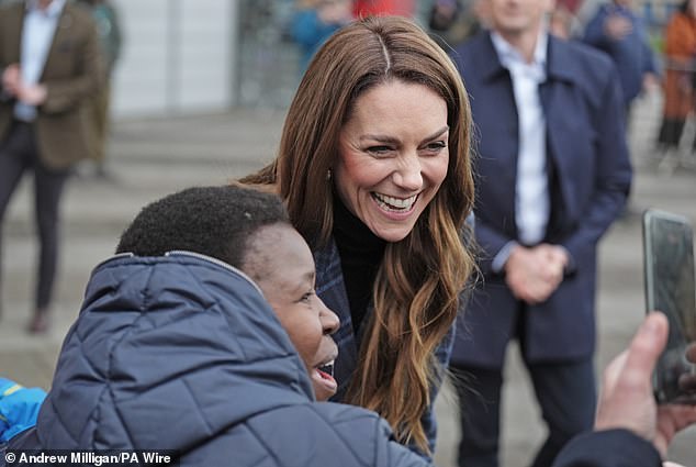 A royal fan poses for a photo with Catherine outside the National Curling Academy in Stirling