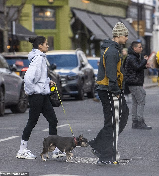Now stepping out amid the fallout, Romeo, 23, appeared tense as he walked his dog with Kim, 24, through the streets of west London