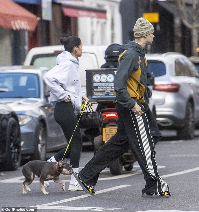 Meanwhile, Kim opted for a laidback ensemble, wearing a grey hoody and black figure-hugging leggings as she clutched the dog lead while crossing the street