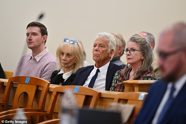 Gilbert and families sit with sullen faces in the gallery as they listen to the prosecutor's argument to keep Busfield in prison ahead of his child abuse trial