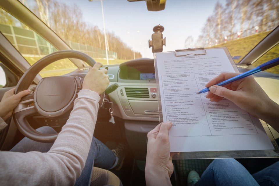 Examiner filling in driver's license road test form