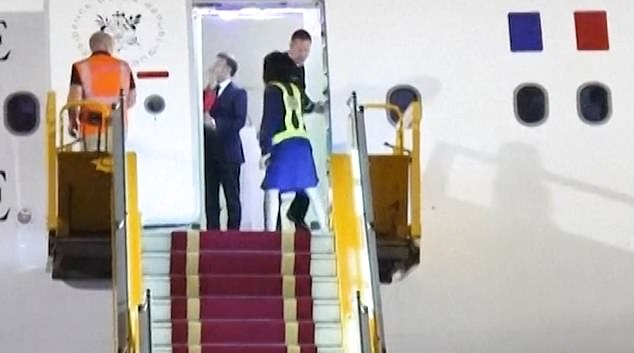 Footage shot by the Associated Press news agency in Hanoi shows Macron's plane door opening to reveal him