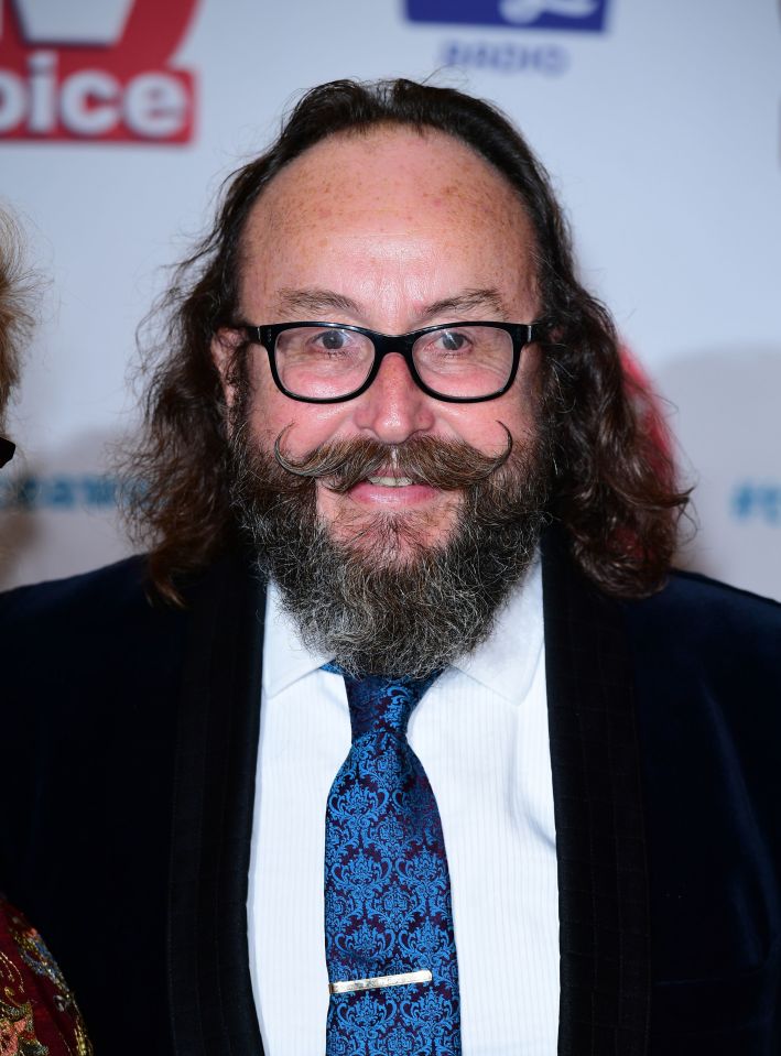 Hairy Biker Dave Myers smiling while wearing a tie and a dark jacket.