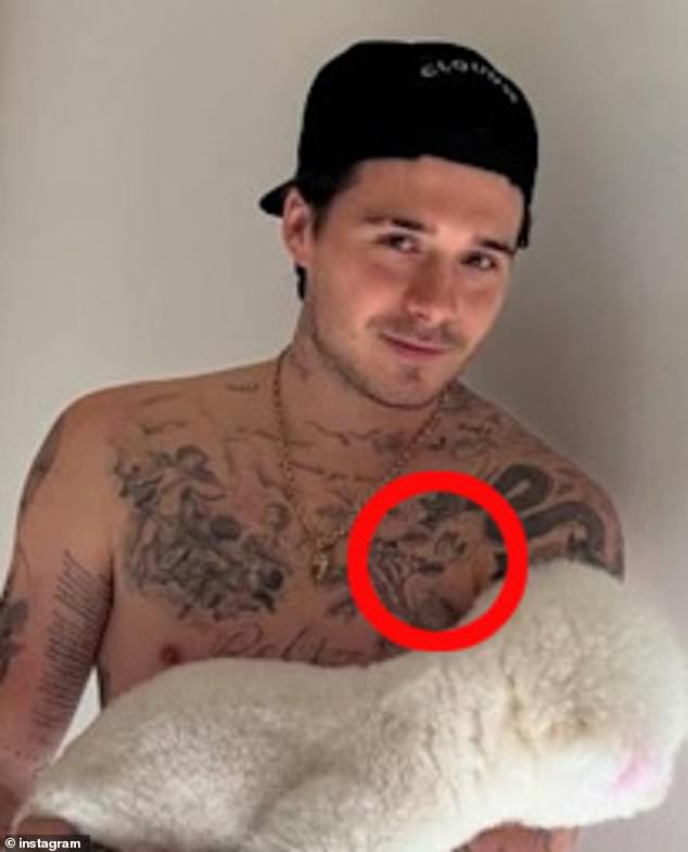 Brooklyn Beckham, 26, recently revealed he has savagely covered up a 'mama's boy' tattoo on his chest in tribute to Victoria (pictured in February