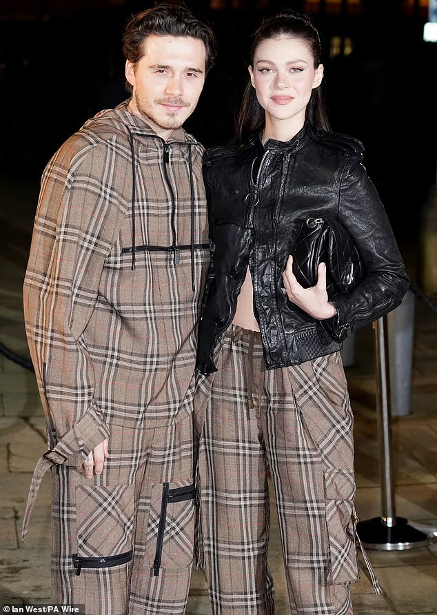Brooklyn and Nicola attend a Burberry fashion show at the Tate in London last year