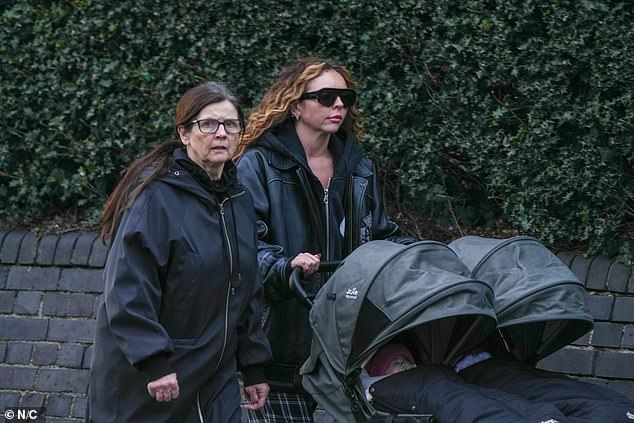 The star pushed her twins along in a double pram as she headed out for a stroll with her mother