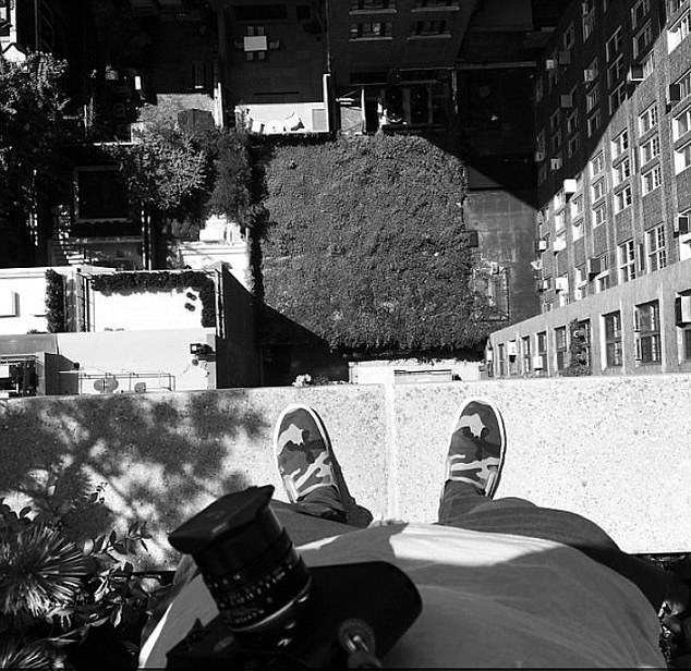 In one picture, readers can only see the corners of Brooklyn¿s shoes as he teeters over the edge of a 16-storey high building to take a bird¿s eye picture of the view below.