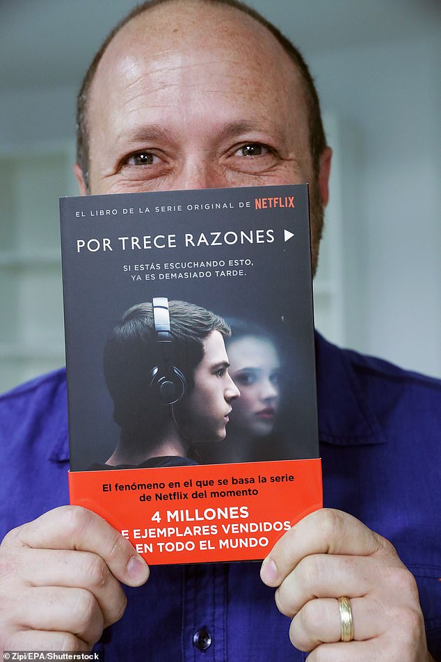 Pictured: Asher posing with his book in Spanish before his career came crashing down