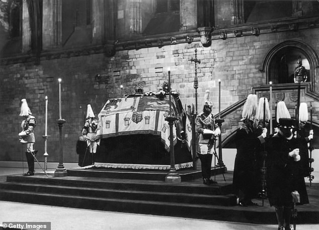 The late King George V lying in state in London's Westminster Hall surrounded by horse guards