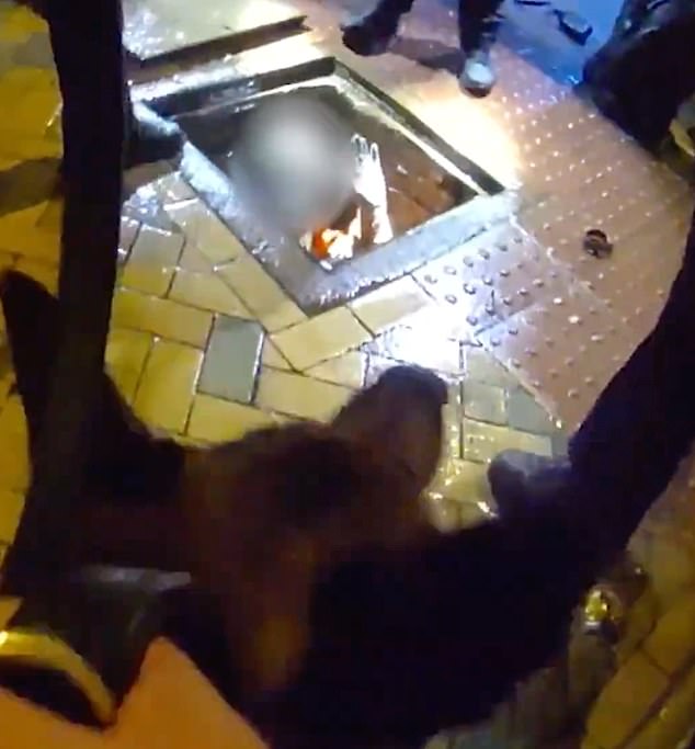 In the clip, shared by West Midlands Police, armed officers and their dogs can be seen swarming a manhole in Birmingham city centre