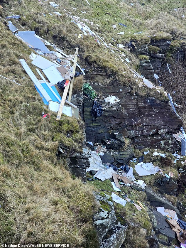 Bits of wood, plastic bags and ripped-up cardboard boxes litter the once beautiful cliffside of Bwlch Mountain in Treorchy, South Wales