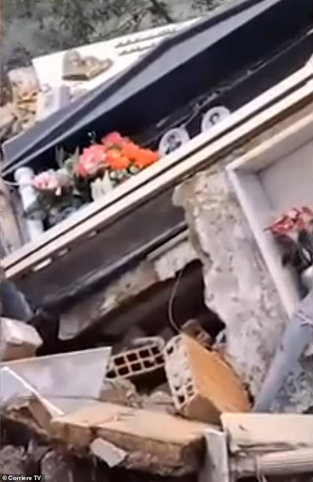 In footage from the scene, wooden wreckage was seen stacked below the cemetery, with floral garlands and framed images of individuals seen scattered amid the debris