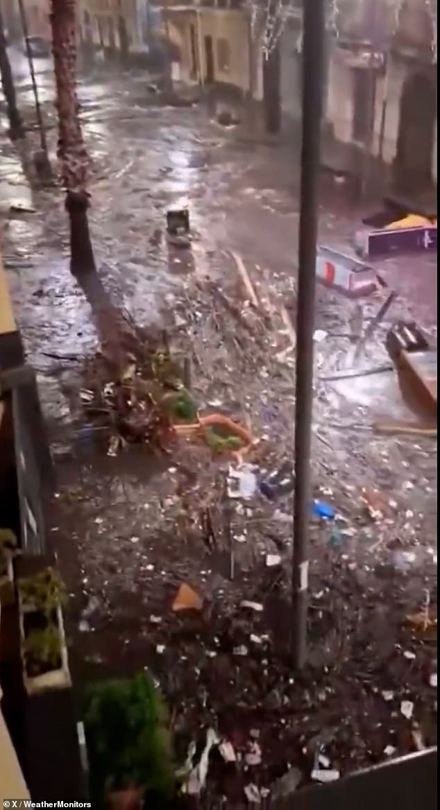 Other videos taken across Sicily showed the damage left behind by the storm surge, with debris and rubbish bags seen floating down the flooded streets