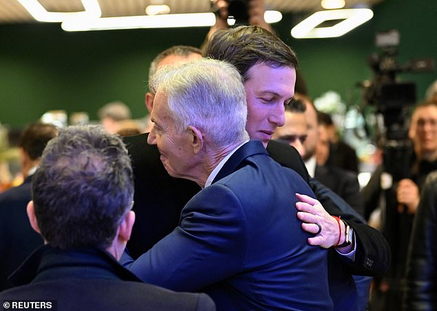 Tony Blair embraces Jared Kushner ahead of the signing ceremony