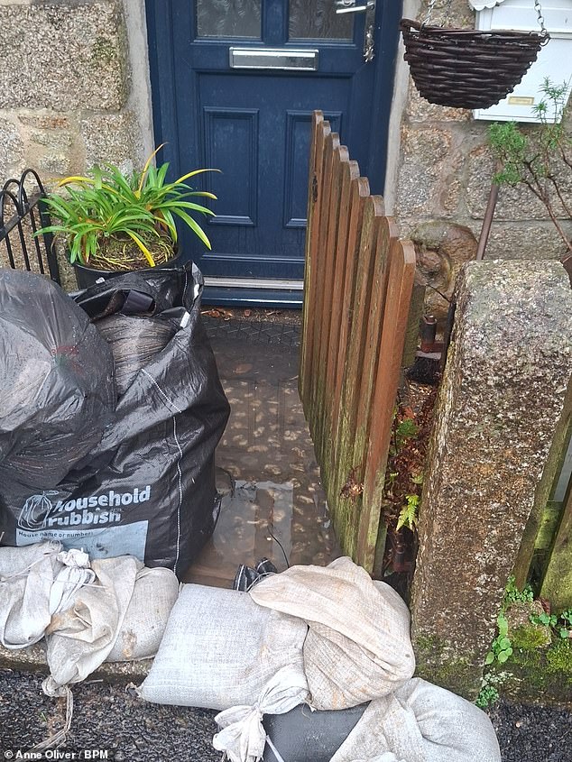 Sandbags piled up outside a home to try and prevent sewage flooding into a house. A flood-reduction project is also being carried out and is due to be completed by May this year