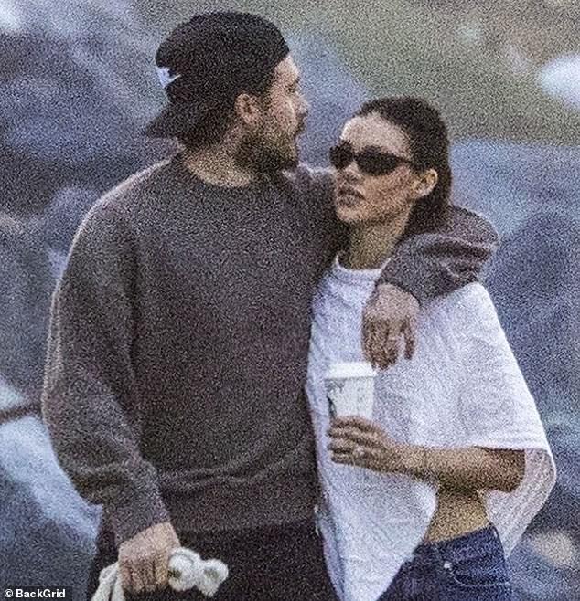 They were wrapped in each other's arms on the walk