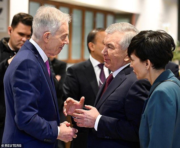 Sir Tony Blair, celebrated angel of peace, was there at the World Economic Forum, palming his business card, cementing connections, writes Quentin Letts