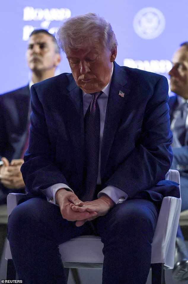 The president seemed to blame the bruising on aspirin that he takes. He is pictured looking down at his bruised hand at the Board of Peace event