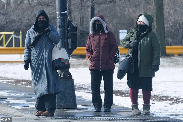 Wind chill will make it feel as cold as -3 degrees Fahrenheit in Dallas, Texas and Arkansas. Pedestrians are pictured bundled up in Chicago, Illinois on Thursday