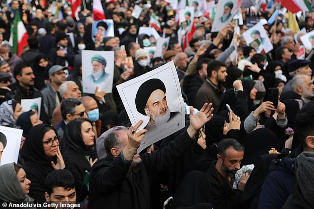 Thousands of people gather in front of Tehran University, carrying banners and chanting slogans against the United States and Israel, as a funeral ceremony is being held for 100 security personnel who lost their lives during the protests
