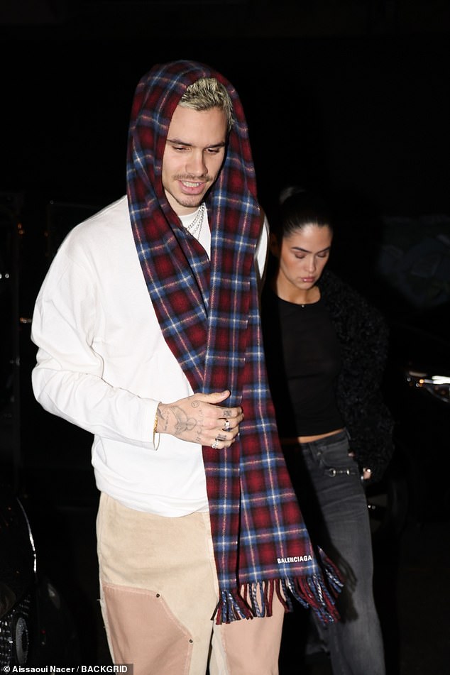 Completing his look, Romeo wore a Balenciaga tartan scarf over his head and a pair of brown boots