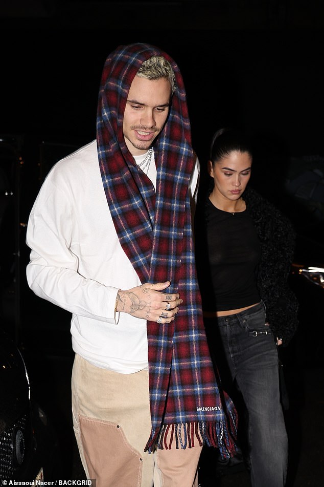 Meanwhile, Kim cut a stylish figure in a black crop top and grey faded jeans, but appeared downcast as she let Romeo lead the way inside