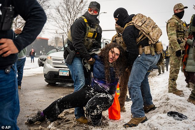 The arrest drew renewed scrutiny to President Trump's immigration crackdown in Minnesota just weeks after the fatal shooting of an anti-ICE protester. An unrelated protester is pictured being detained by ICE in Minneapolis on January 21