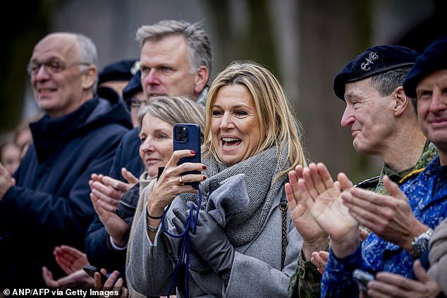 She could be seen holding back tears as she sat alongside other military mothers before snapping her own pictures