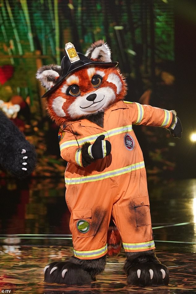 One celebrity is disguised as a panda dressed as a fireman