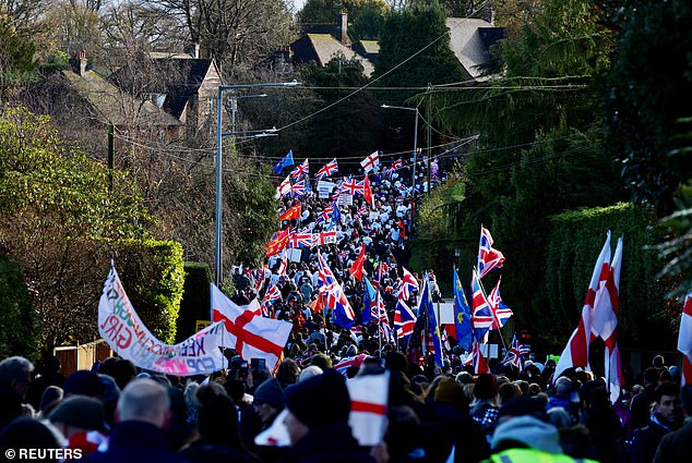 People attend a protest against asylum seekers being housed at an army training camp in Crowborough, Britain, November 23, 2025