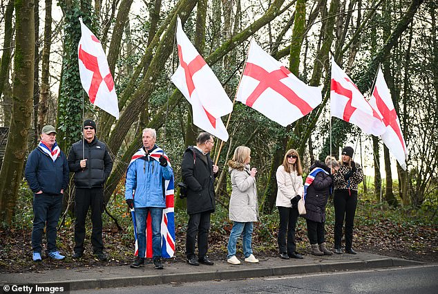Crowds gather outside Crowborough training camp with flags and banners ahead of the peaceful protest on December 14, 2025