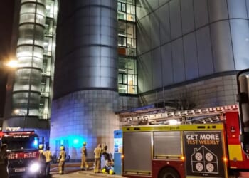 Fire erupts inside huge 13-storey tower in city as 60 firefighters attend scene