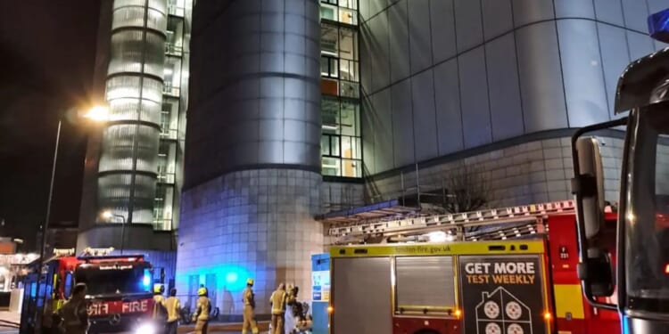 Fire erupts inside huge 13-storey tower in city as 60 firefighters attend scene