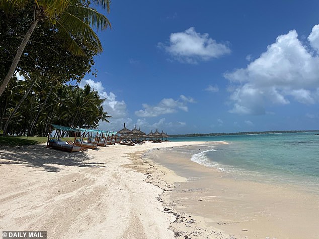 The resort sits on the coastline of the tropical island, with the happy couple seen heading down to the beach soon after their arrival