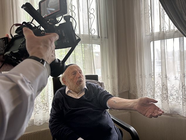 Hershel Herskovic, here showing his number tattoo, was among those who escaped the gas chambers, after being told that Josef Mengele needed them for work