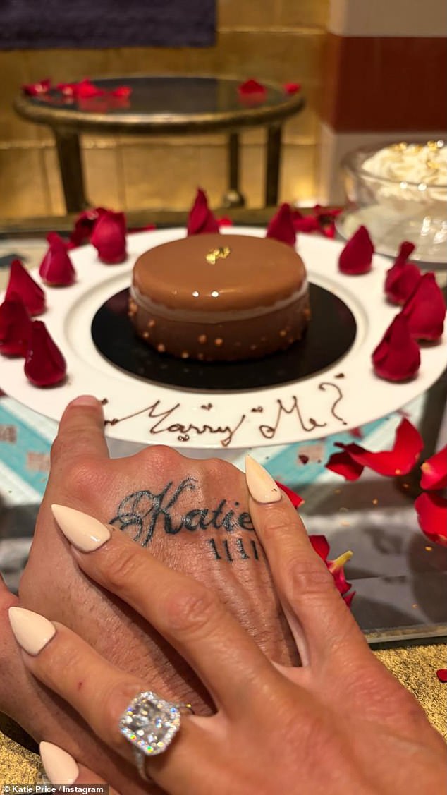 She also showed off her partner's hand, which had a fresh tattoo of her name inked on, and revealed the pair were celebrating with champagne, strawberries and chocolate cake