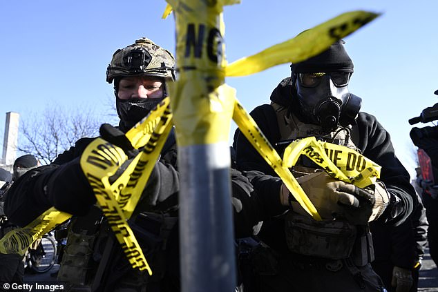 Federal agents tied police tape on a pole to block off the scene of a shooting on January 24 in Minneapolis, Minnesota