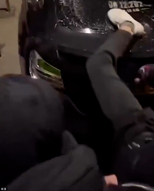 Videos online showed groups of people smashing car windows and windscreens with their feet