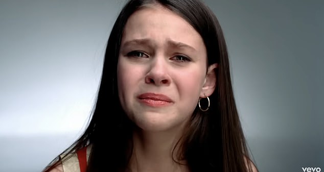 Peltz herself clutches a stuffed animal in one shot as tears stream down her cheeks