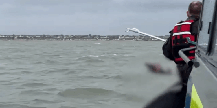 Moment two men 'minutes from drowning' are spotted in desperate rescue attempt after being swept out to sea