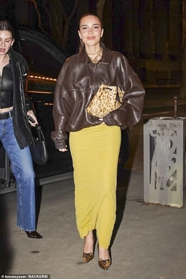 Jackie was dressed in a fun mustard yellow dress with a brown leather bomber jacket