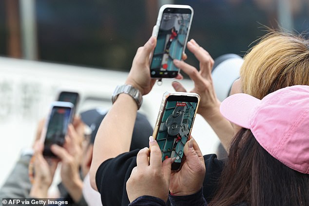 Cheers erupted from a gathered crowd as he started climbing the tower on Sunday morning